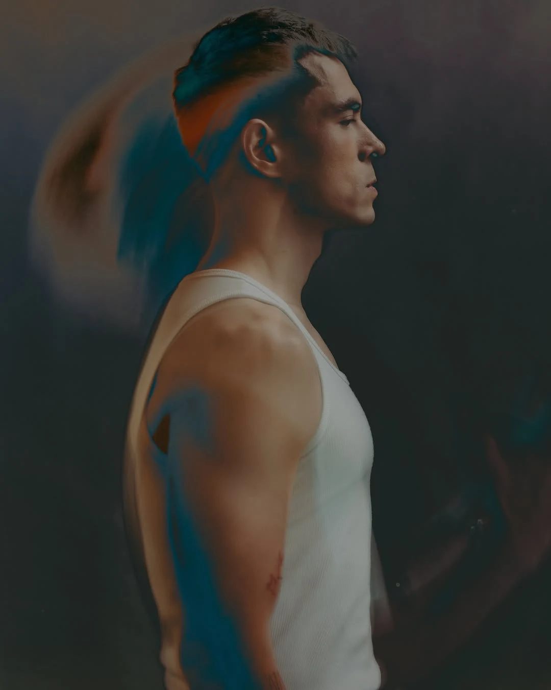 Jake Cuenca 穿白色背心侧身，展示肩臂线条